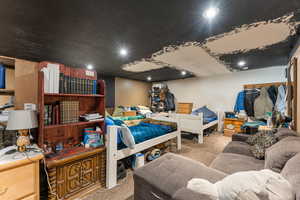 Carpeted bedroom with recessed lighting