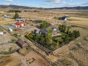 Aerial view of property and surrounding area with rural landscape and a mountainous background