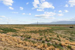 View of mountain backdrop featuring rural landscape