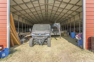 View of vehicle parking featuring an outbuilding