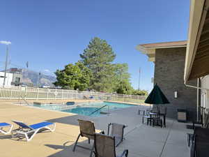 Community pool with patio area and a mountain view