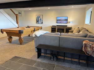 Family room featuring carpet and tile at basement entry