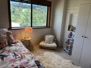 Bedroom with large east facing window and wardrobe closet