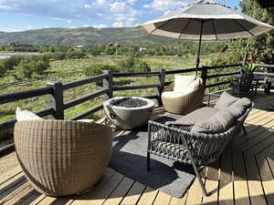 Wooden deck featuring a mountain and lake view to the west