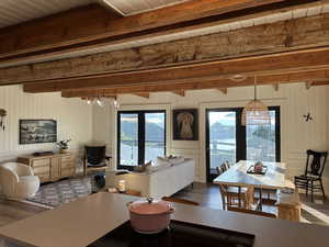 Open floor plan living room, dining room kitchen with west facing view of lake