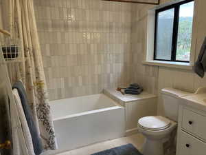 Full bathroom featuring tile floor, plenty of natural light, vanity, and shower / bathtub combination
