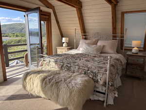 Upstairs bedroom with windows to the south, west and east and west facing balcony