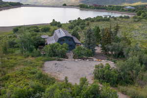 View of subject property featuring large upper parking area, private wooded lot , view of Witts Lake and mountains