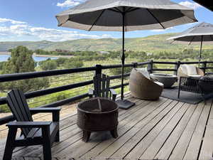 Wooden deck featuring a water and mountain view