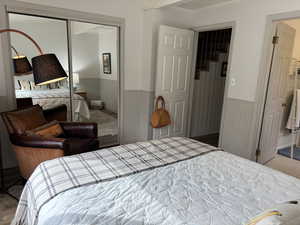 Main floor bedroom with mirrored sliding closet doors