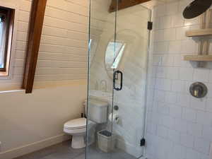 Upstairs bathroom with tiled shower and glass surround