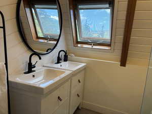 Upstairs bathroom featuring double vanity