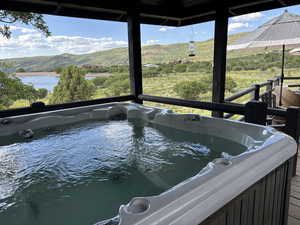 Hot tub with view of lake and mountains