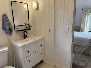 Ensuite bathroom with vanity and wooden walls