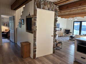 Hallway to main floor bedroom and door to basement