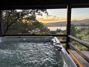 Hot tub with sunset view of lake and mountains