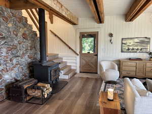 Living room with wood burning stove and one of three accesses to wrap around deck