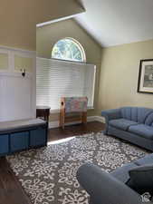 Living room featuring wood finished floors and lofted ceiling