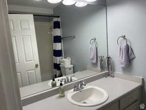 Full bath featuring vanity and shower / bath combo with shower curtain