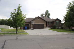 Ranch-style house featuring an attached garage, driveway, and stucco siding