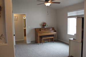 Sitting room featuring a ceiling fan and carpet floors