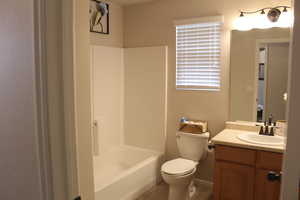 Full bath with vanity, tile patterned floors, and tub / shower combination