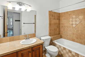 Bathroom featuring vanity and tiled shower / bath