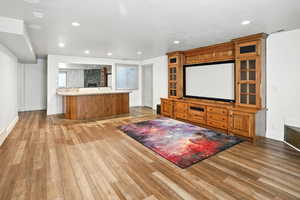 Home theater featuring light wood-style flooring and recessed lighting