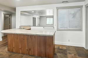 Kitchen with recessed lighting, light countertops, and a peninsula