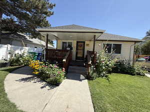 View of front of property featuring covered porch and roof with shingles