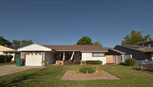 Single story home with an attached garage and concrete driveway