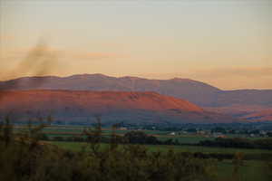 View of mountain background featuring rural landscape