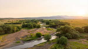 View of mountain backdrop with rural landscape