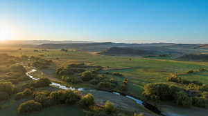 Aerial view of property and surrounding area featuring mountains and rural landscape