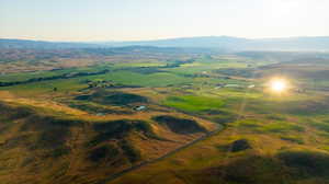 Aerial view of property's location featuring a mountainous background and rural landscape
