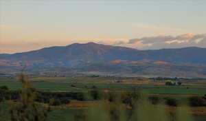 View of mountain background featuring rural landscape