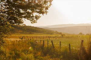 View of mountain backdrop with rural landscape