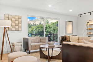 Living room featuring rail lighting, recessed lighting, and a mountain view