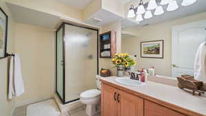 Full bathroom with a shower stall, tile patterned floors, and vanity