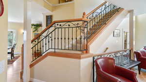 Stairs with wood finished floors and ornamental molding