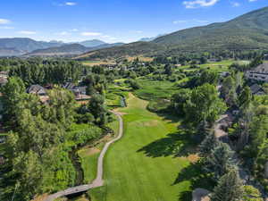 Drone / aerial view of a mountainous background and 13th hole of golf course
