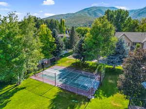 Bird's eye view of tennis/pickleball and basket ball court with a mountain backdrop
