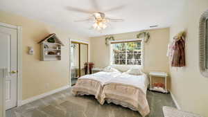 Bedroom with carpet flooring, a closet, and ceiling fan