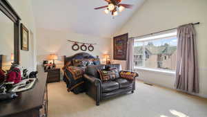 Master Bedroom with light carpet, high vaulted ceiling, and ceiling fan