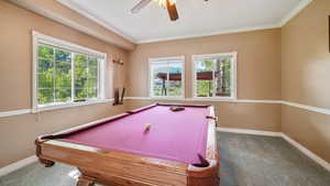 Game room with carpet floors, billiards table, a ceiling fan, and ornamental molding