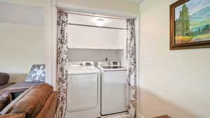 Washroom featuring washing machine and dryer