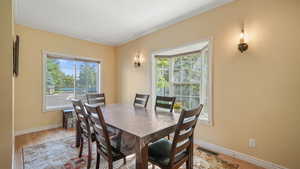 Dining area featuring ornamental molding and light wood-type flooring