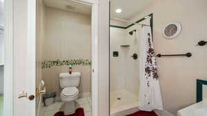 Master Bathroom featuring a stall shower and tile patterned flooring