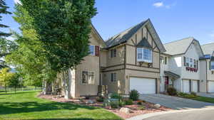 House featuring stucco siding, a garage, concrete driveway, and a shingled roof