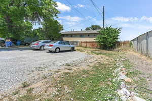 View of yard featuring gravel driveway and extra parking